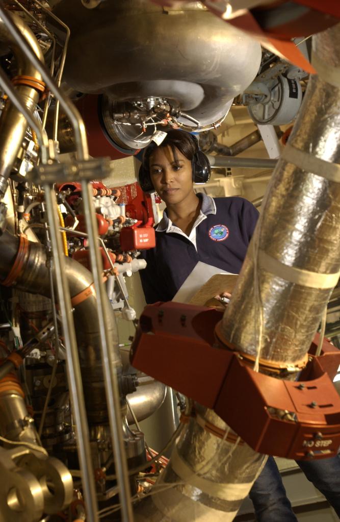 A NASA Stennis engineer inspects a space shuttle main engine