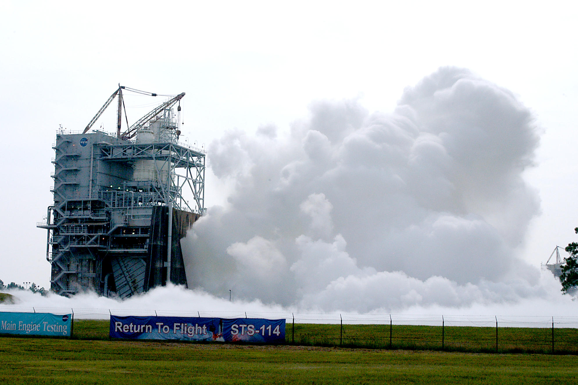 vapor clouds erupt towards the sky during a space shuttle main engine test