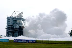 vapor clouds erupt towards the sky during a space shuttle main engine test