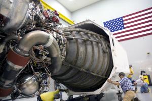 crew examining space shuttle flight engine No. 2061 inside a facility at NASA Stennis