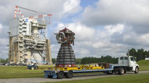space shuttle main engine No. 0525 sitting on trailer; test stand is seen in the background