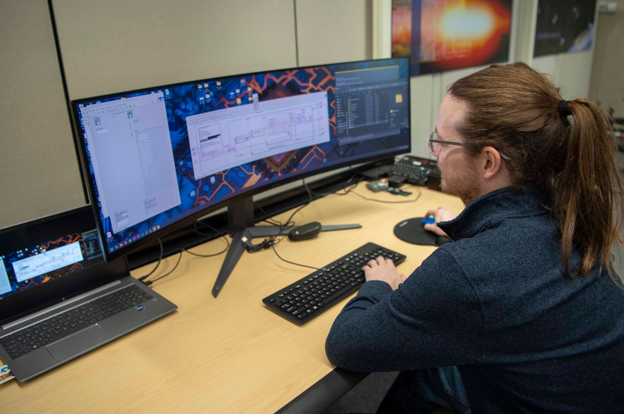 NASA software engineer Brandon Carver is seated at a desk