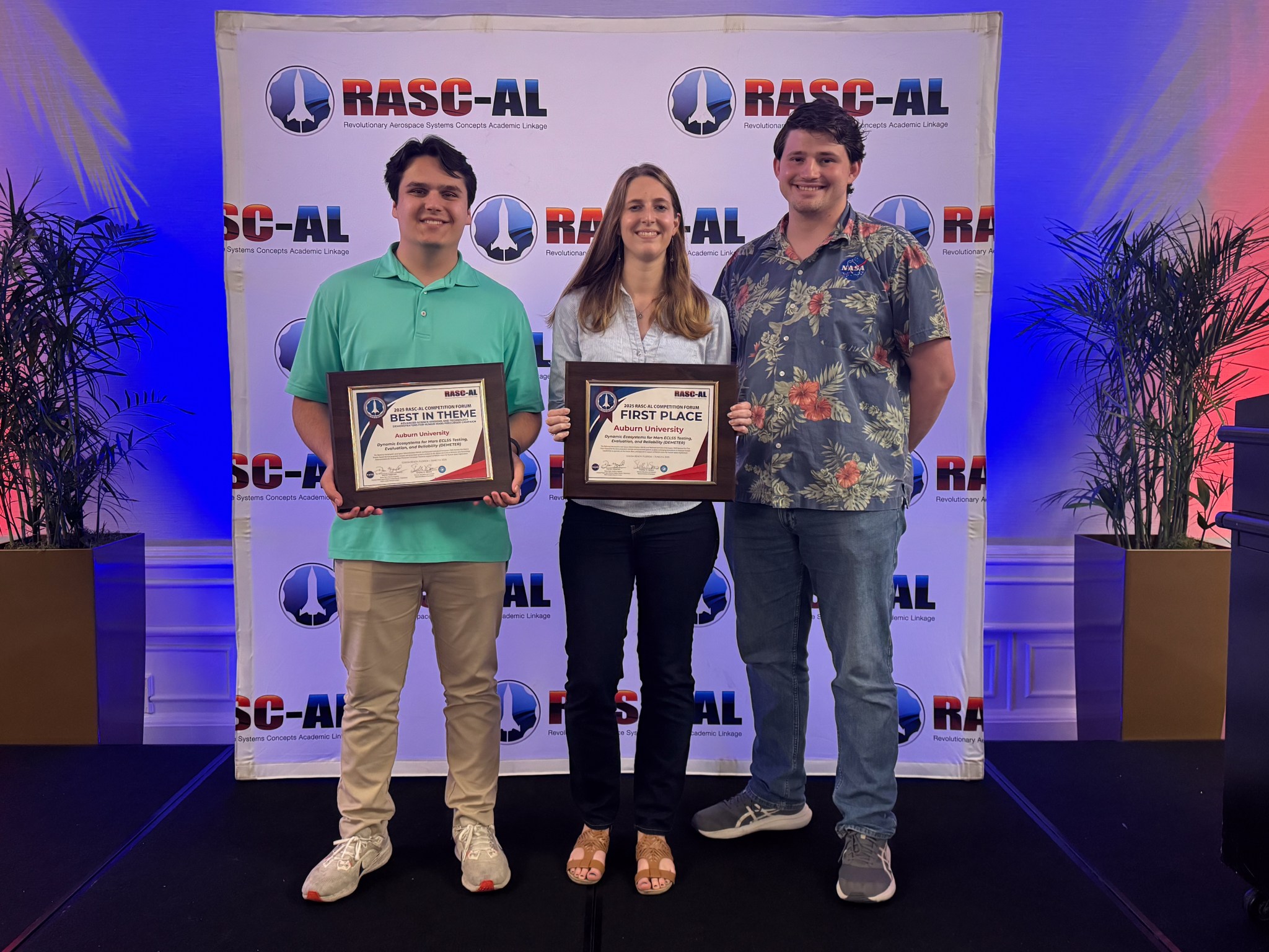 The three members of Auburn University's 2025 RASC-AL team hold their awards for first place overall and best in theme.