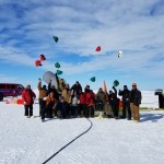 Crew members celebrating a successful balloon launch in Antarctica.