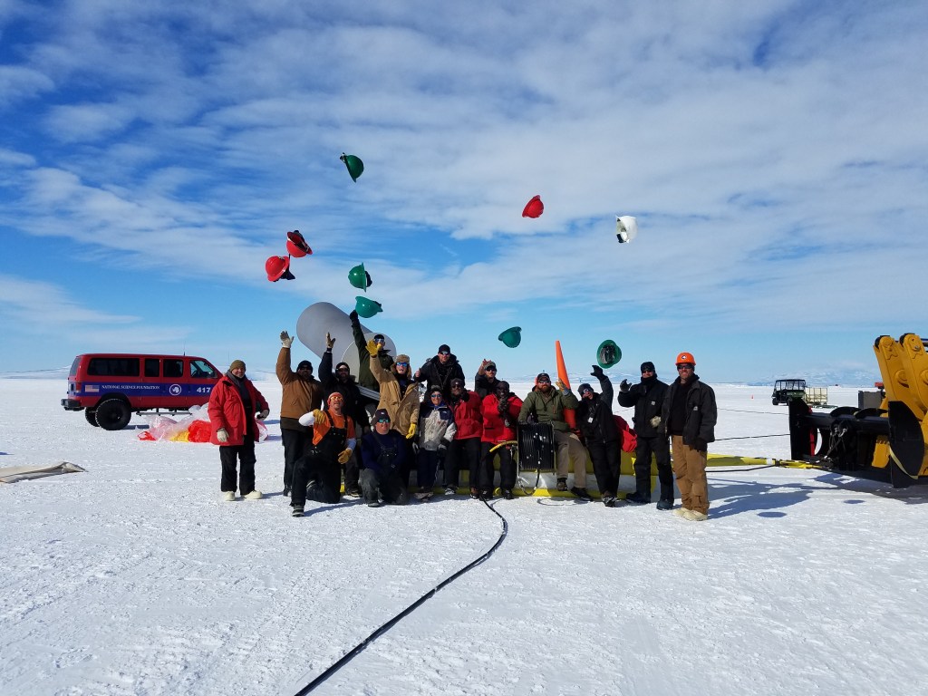 Crew members celebrating a successful balloon launch in Antarctica.