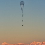 A balloon ascending above clouds.
