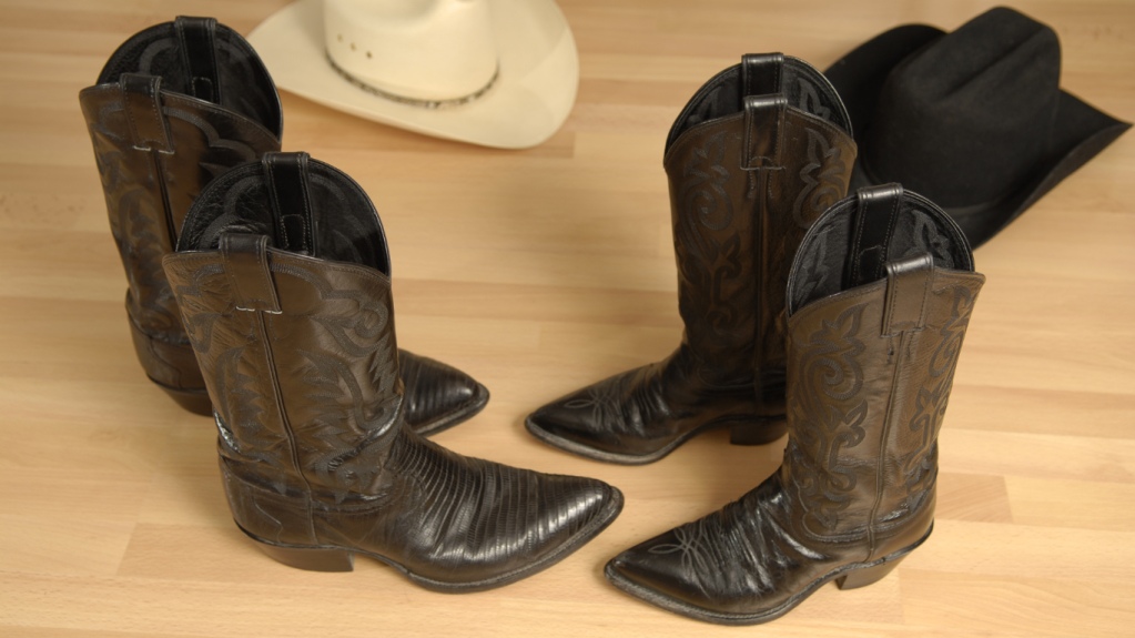 Cowboy hats and boots on a wooden dance floor.