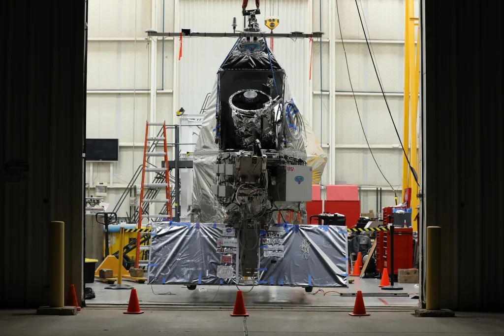 Payload and launch vehicle in a high bay.