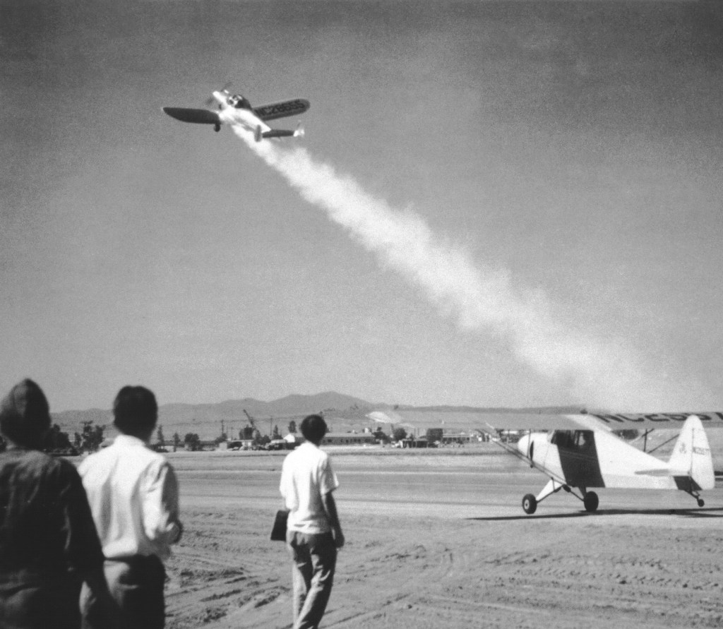 Men watching aircraft takeoff.