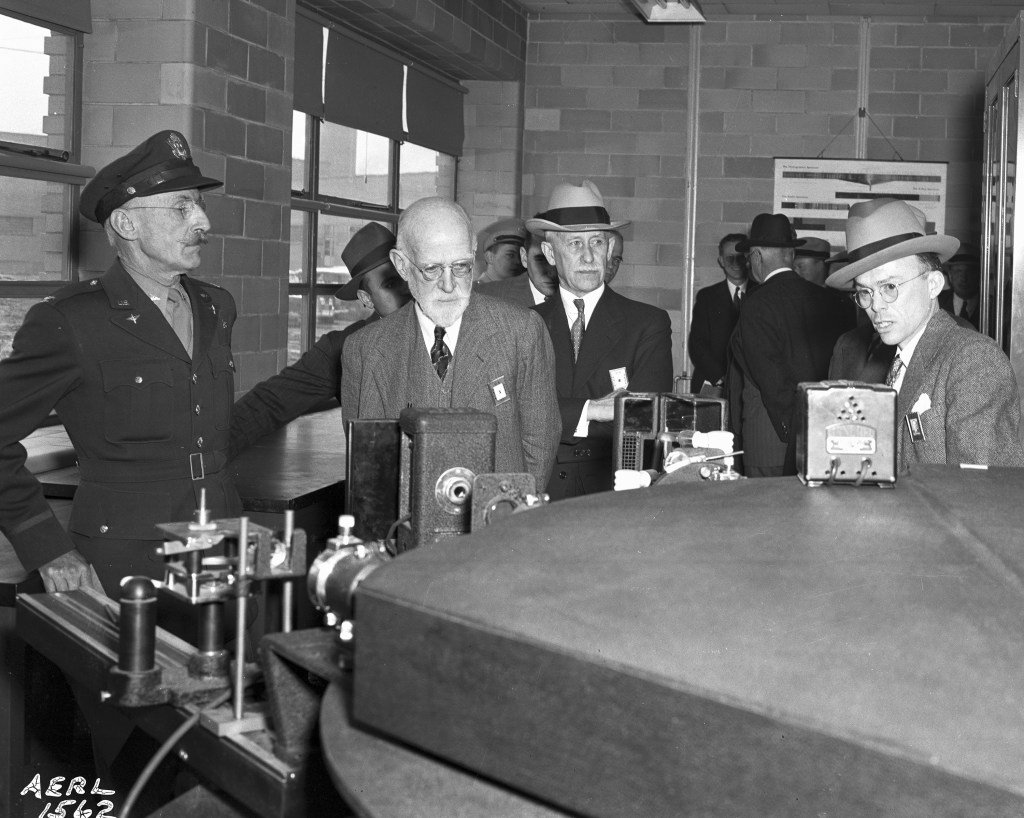 Men view equipment in test cell.