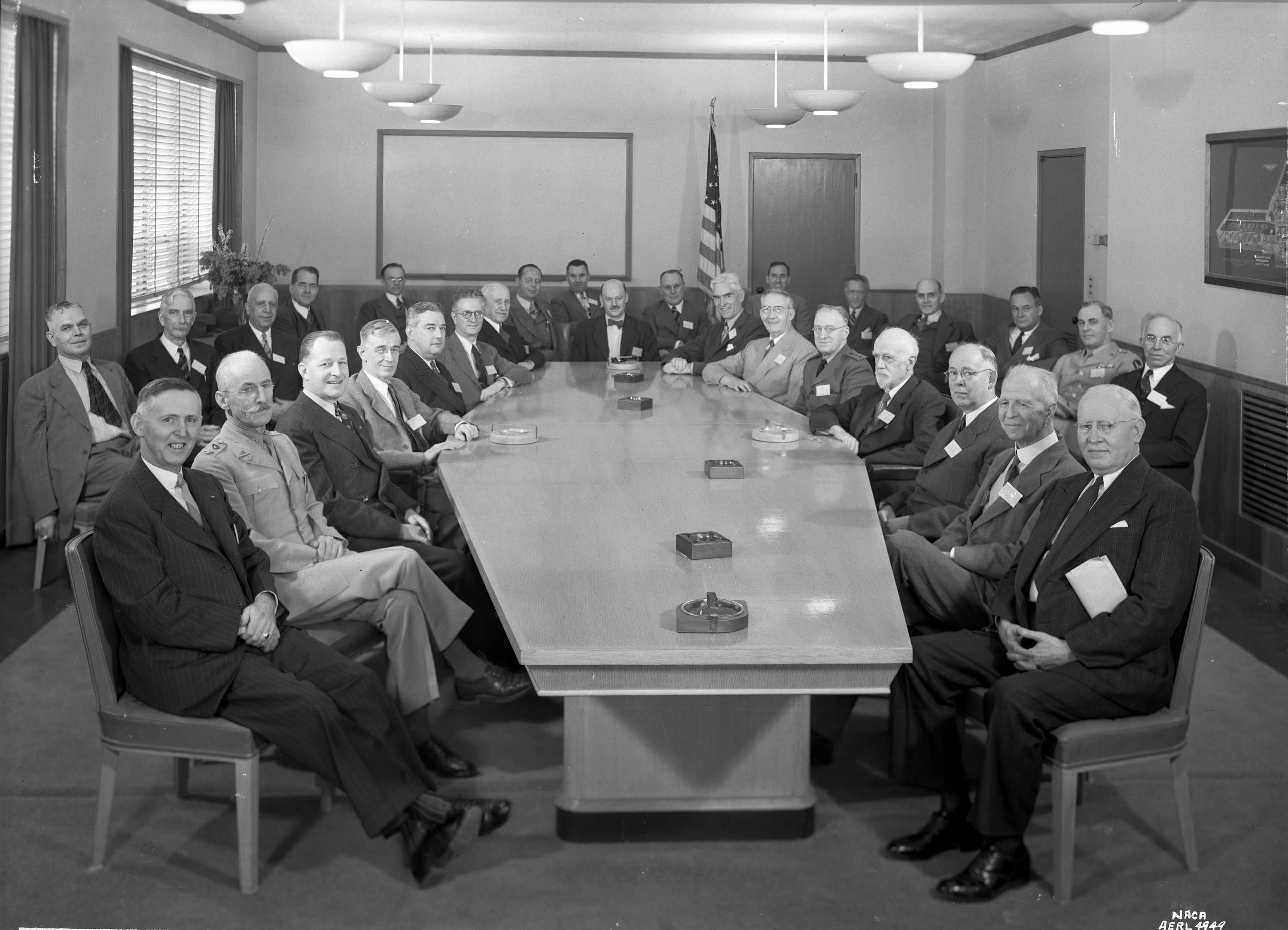 Group of people sitting at confernce table.