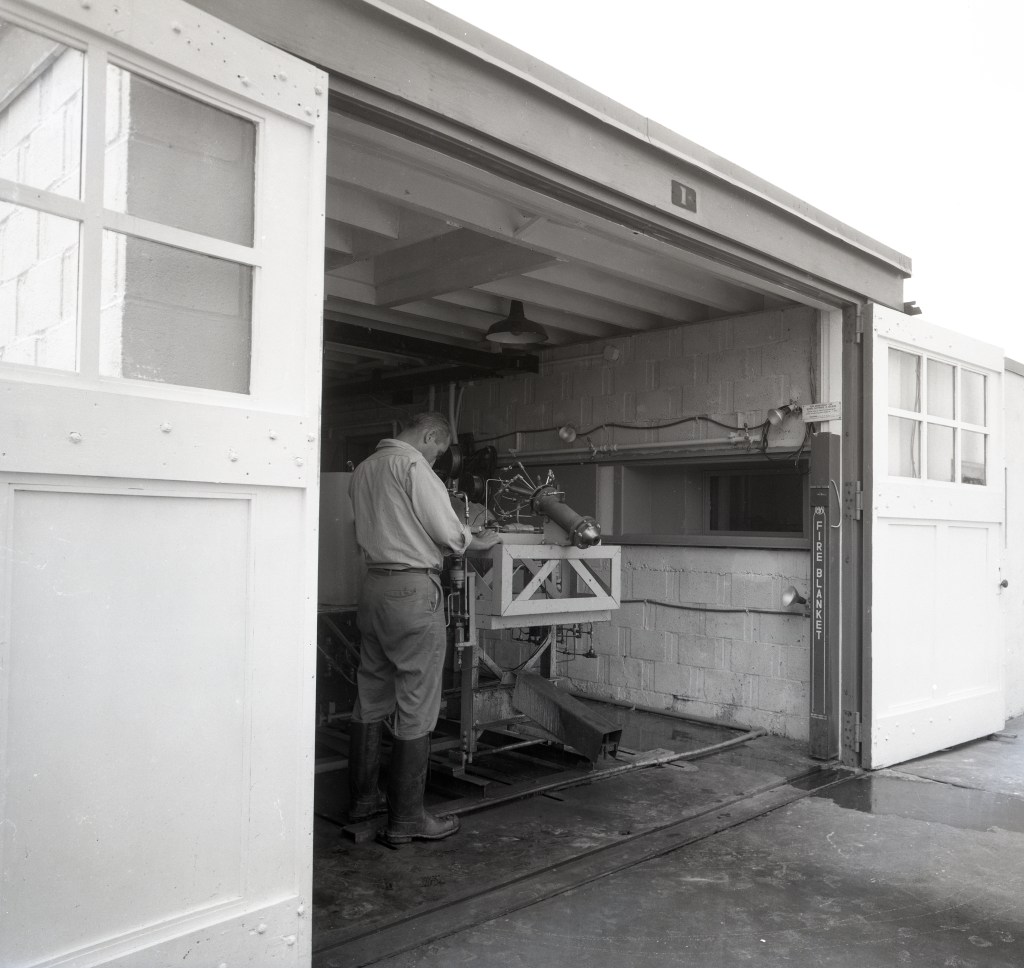Man working on test equipment.