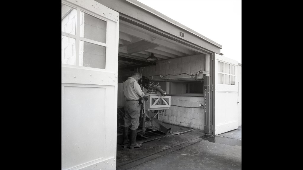 Man working on test equipment.