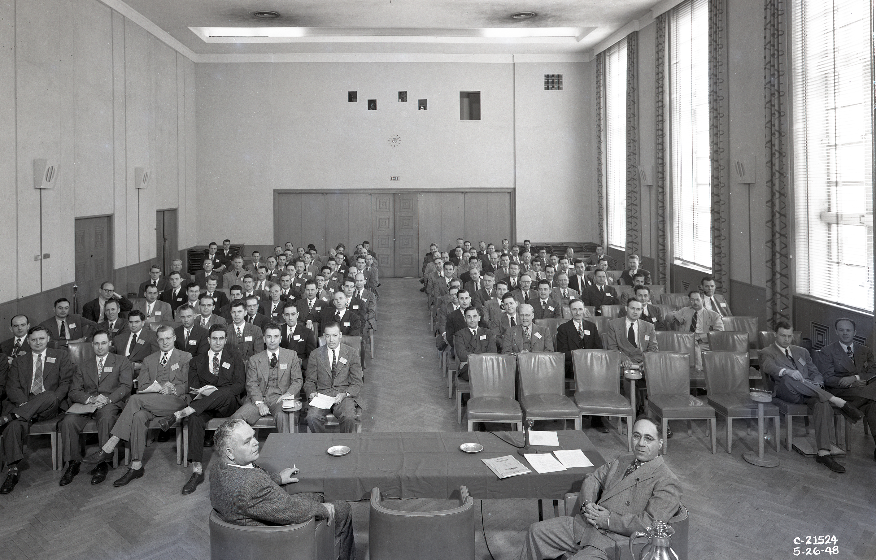 Large group seated in auditorium.