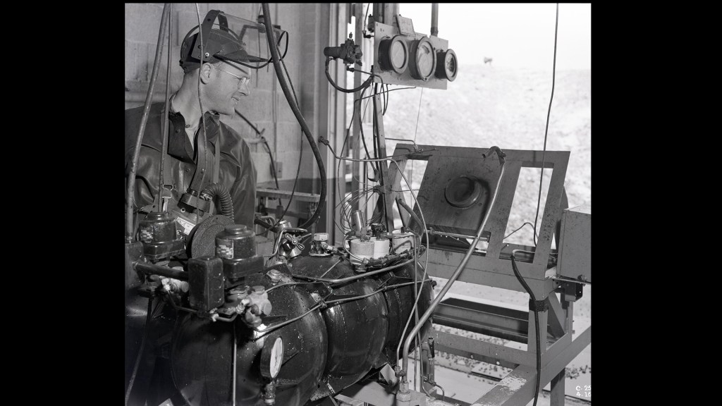 Man looking at test equipment.