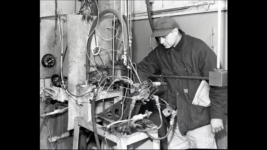 Man examining damaged hardware.