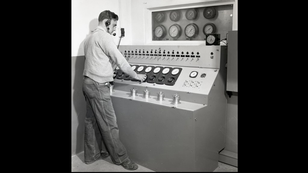 Man at control panel.