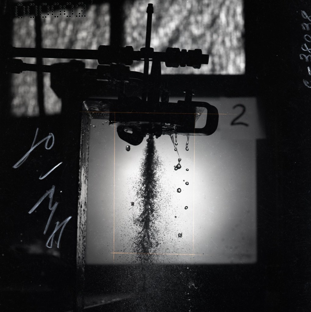 Fuel injector spraying fluid.