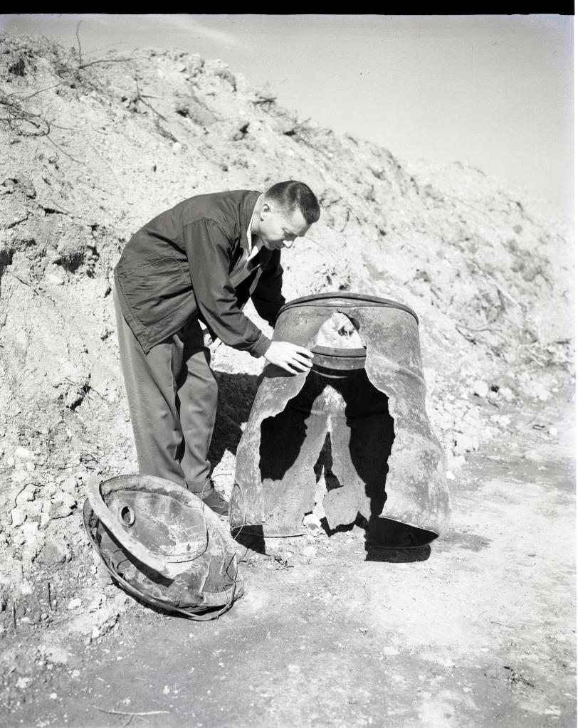 Man examining damaged hardware.