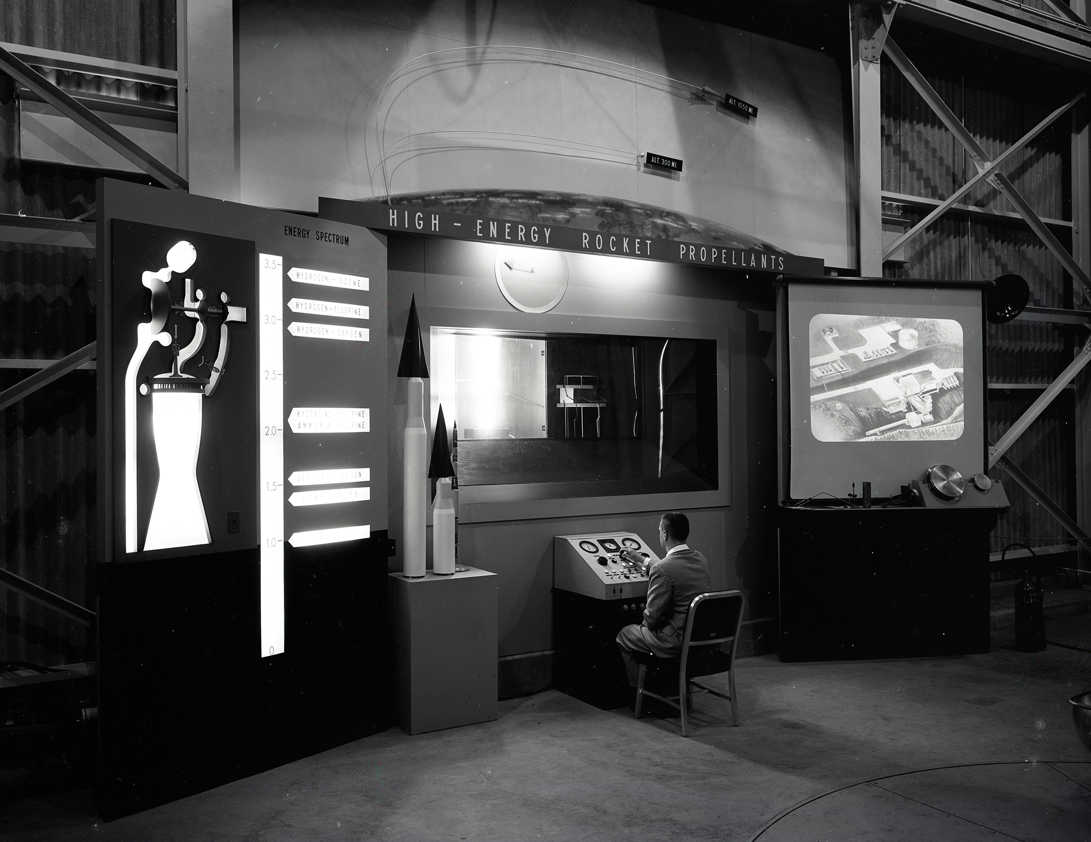 Man seated at control panel at RETF display.