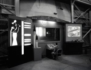 Man seated at control panel at RETF display.
