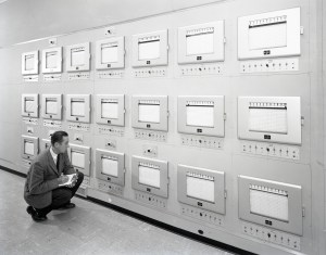 Engineer kneeling and reading charts