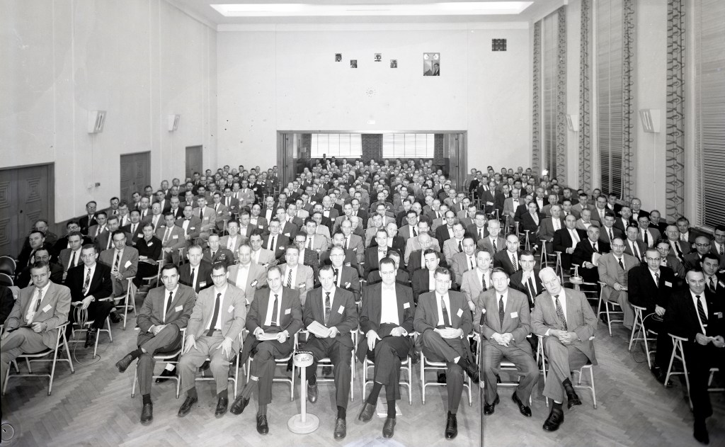 Group seated in auditorium.