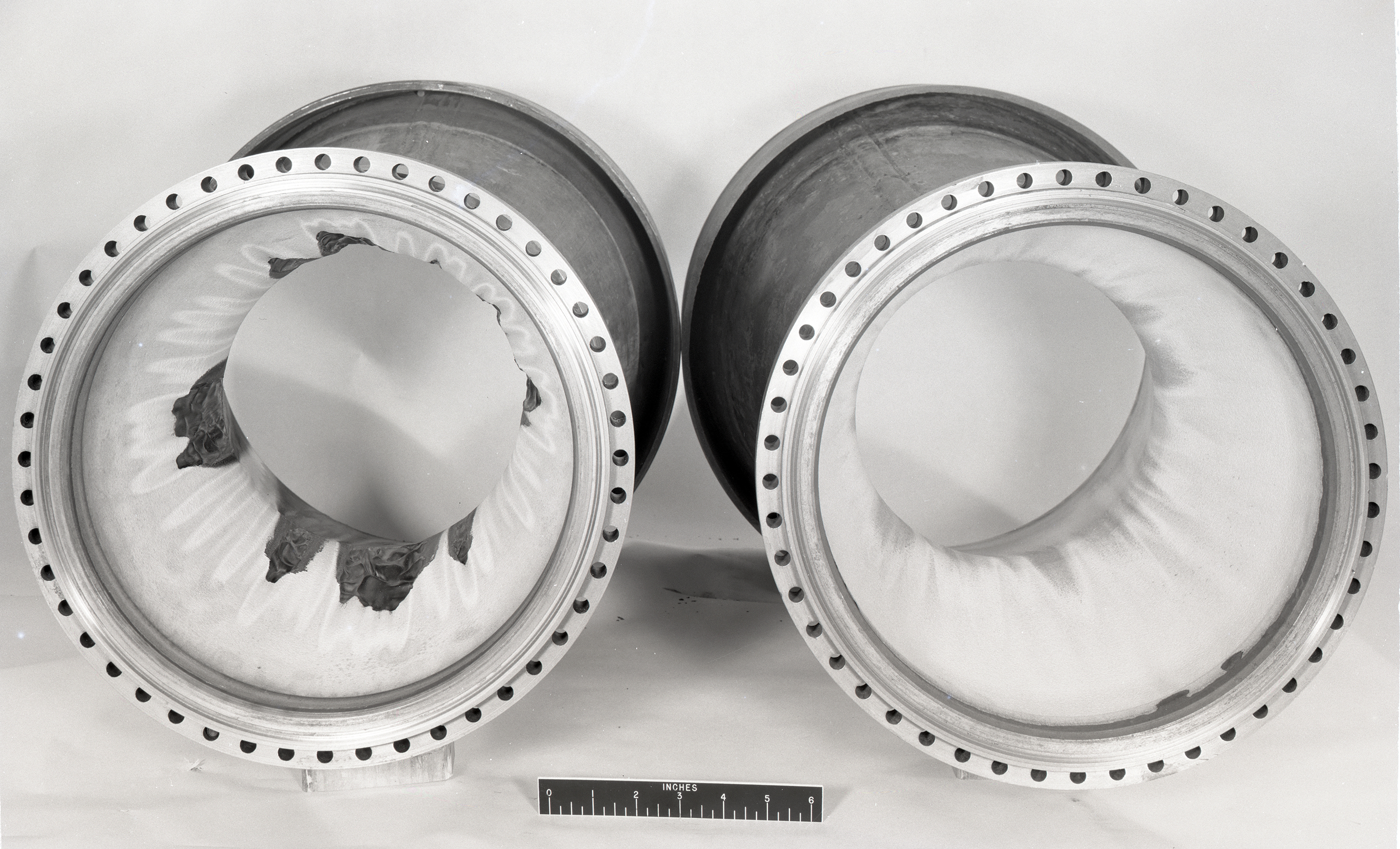 Two tubular thrust chambers with damage.