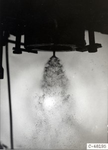 Injector spraying fluid downward.