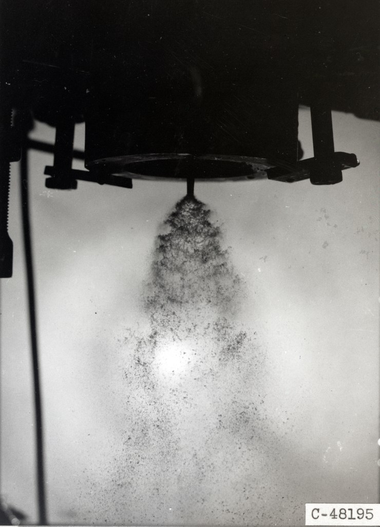 Injector spraying fluid downward.