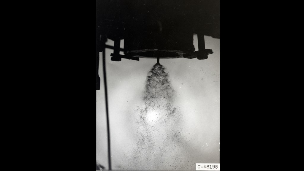 Injector spraying fluid downward.