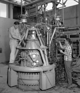 Two mechanics working on test stand.