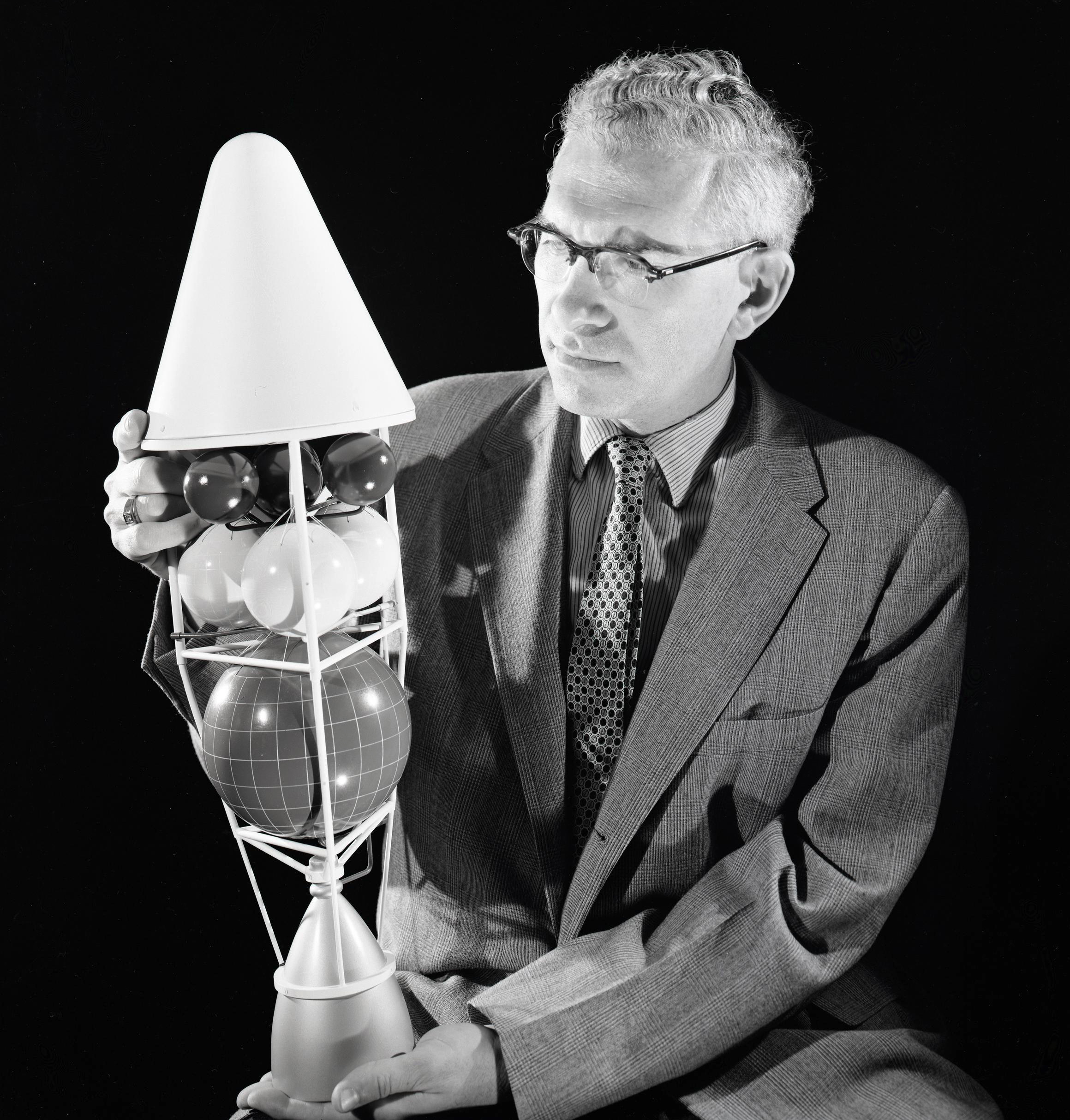 Man holding rocket model.
