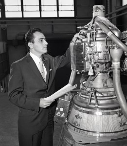 Man viewing small rocket engine.