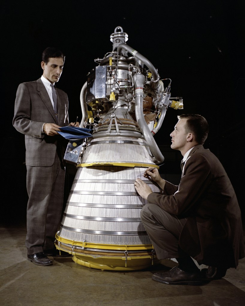 Two men with rocket engine.