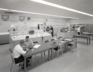Men at various stations in control room