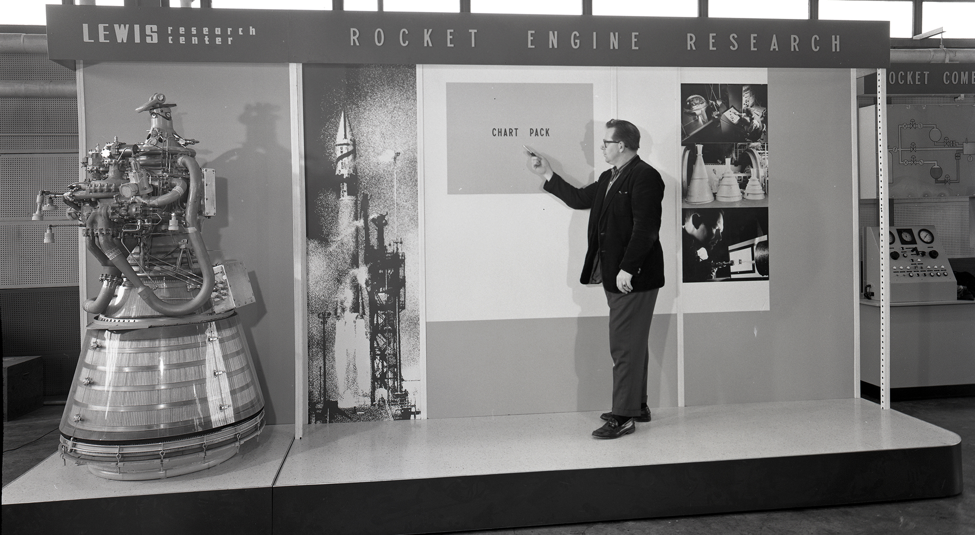 Researcher with engine exhibit.