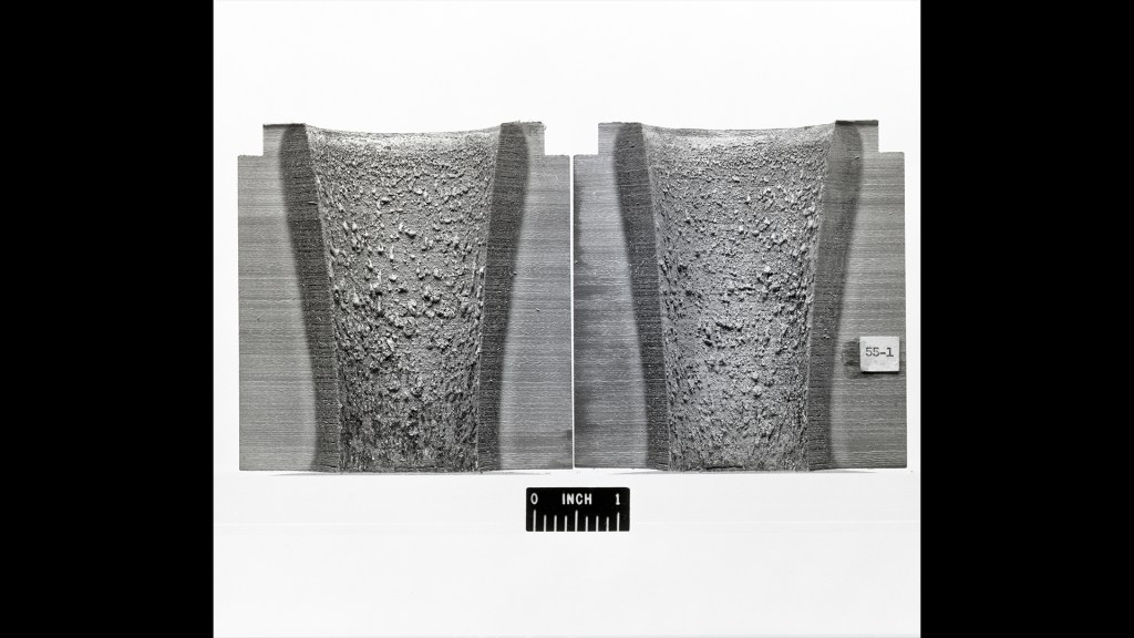 Two halves of rocket nozzle lined with ablative materials.