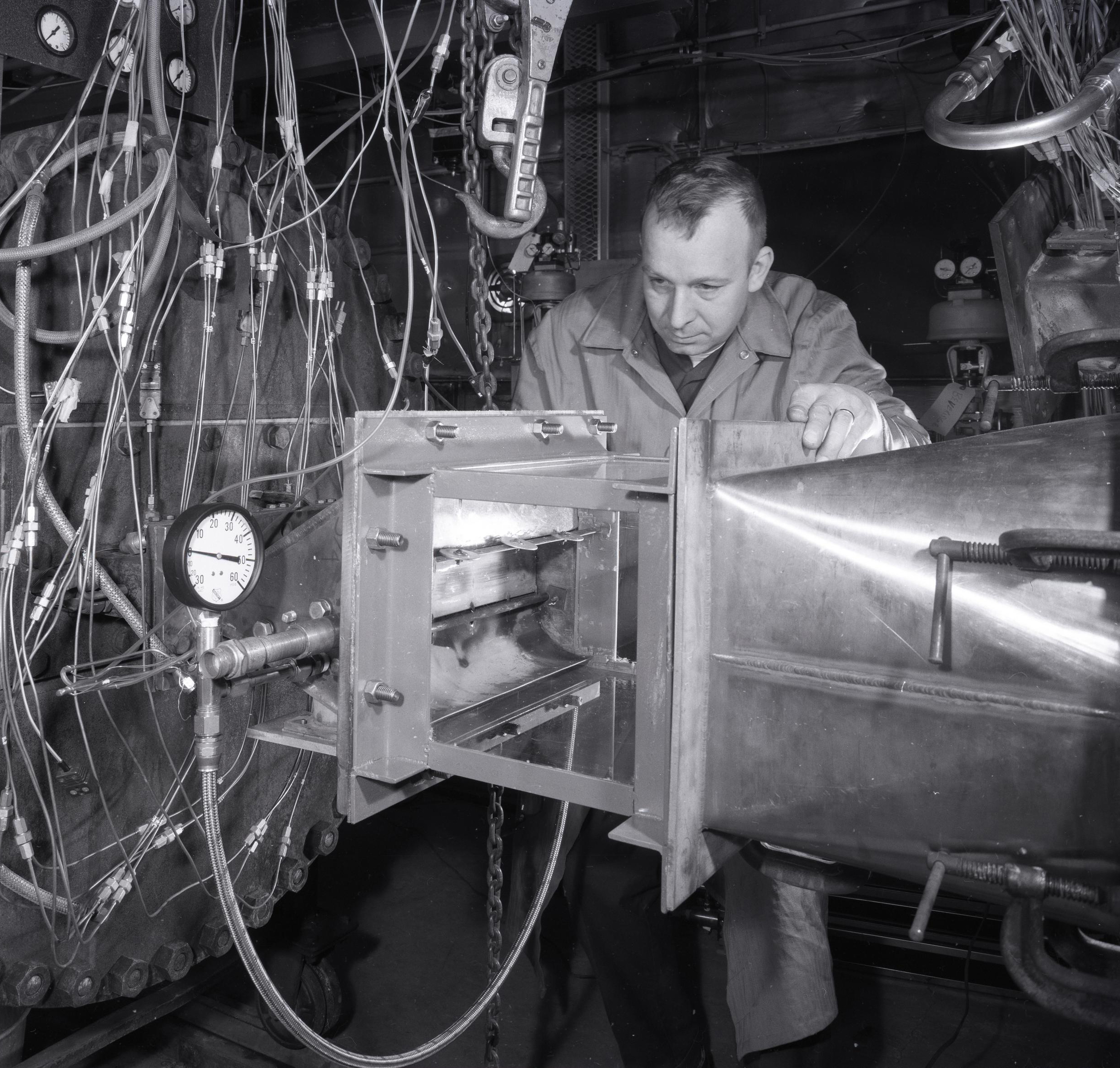 Man examining engine.