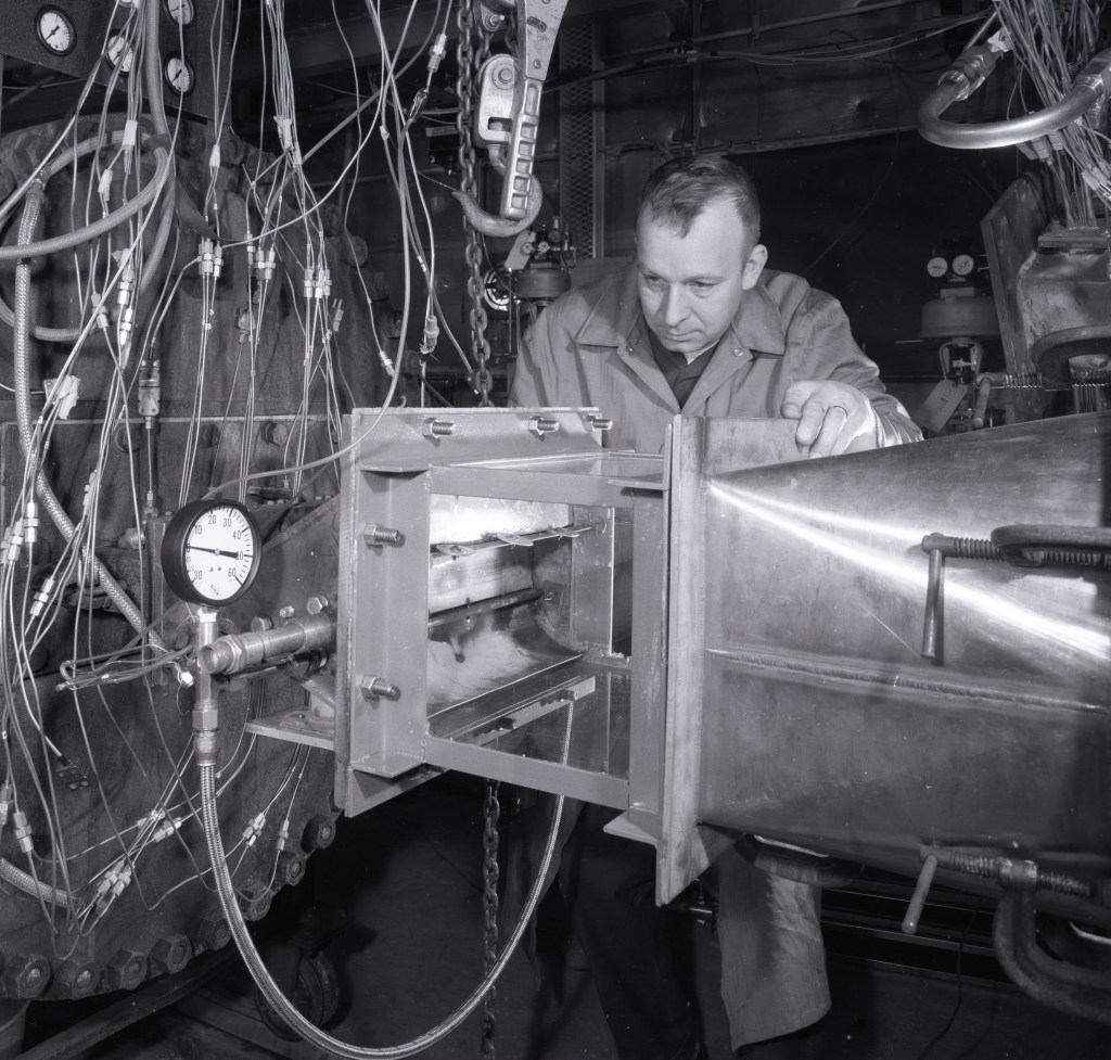 Man examining engine.