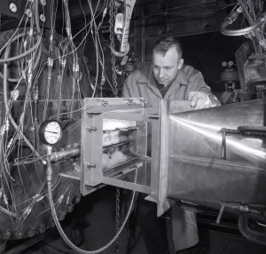 Man examining engine.