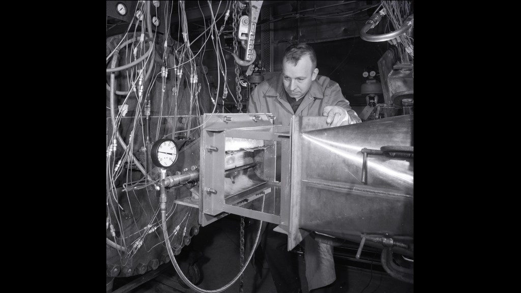 Man examining engine.