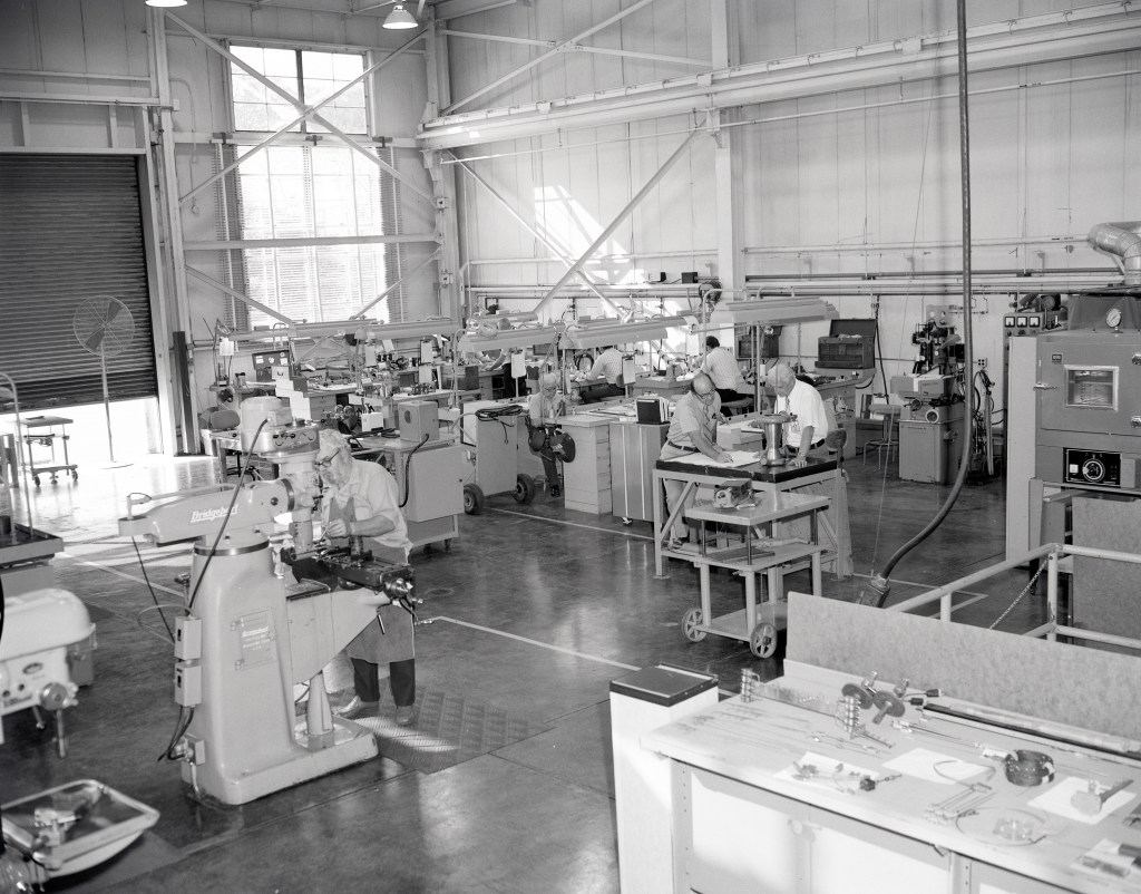 Men working with equipment in shop
