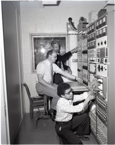 Men in small control room.
