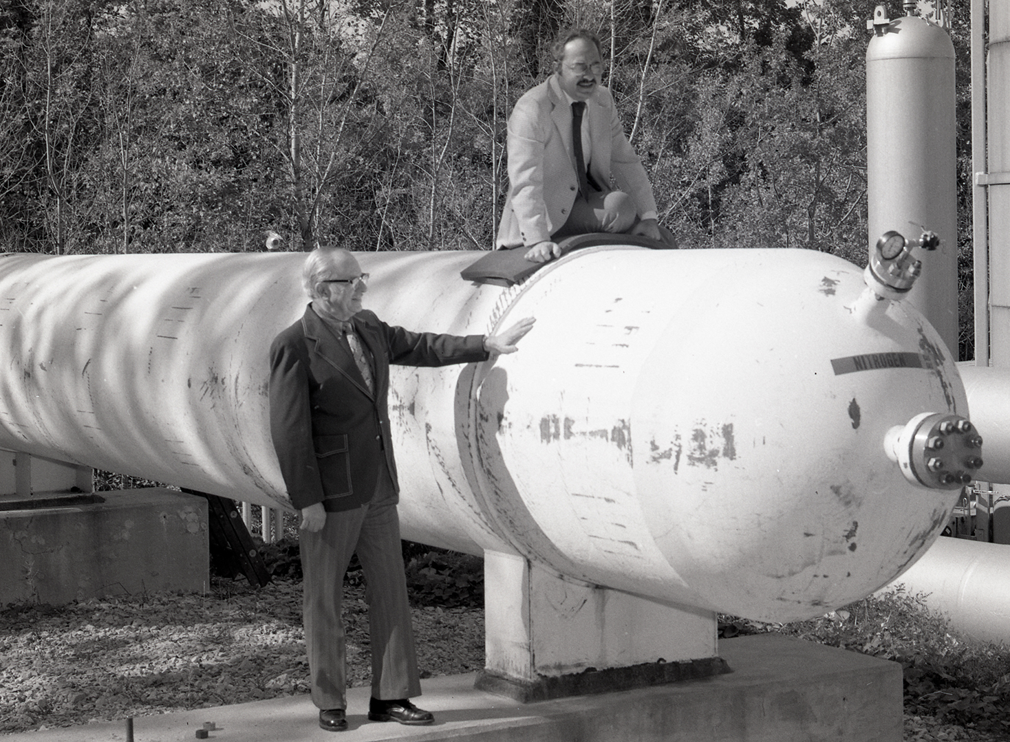 Two men with air storage tank.