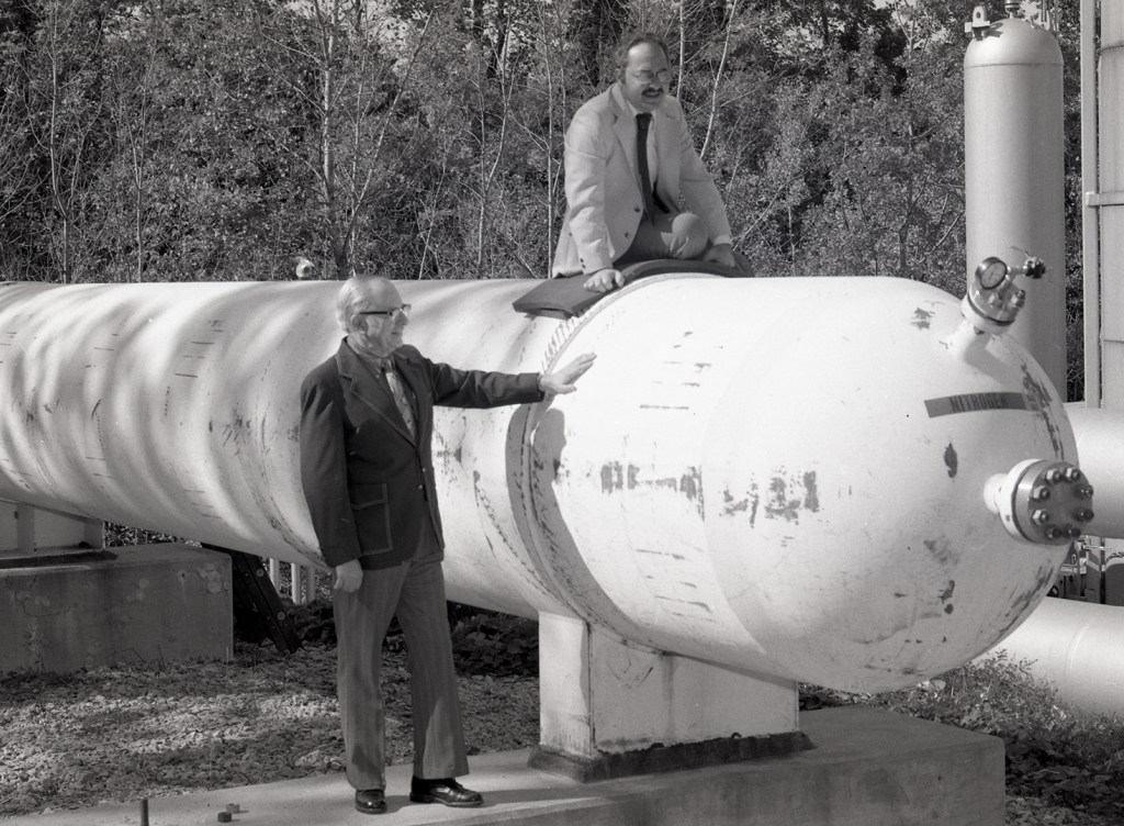 Two men with air storage tank.