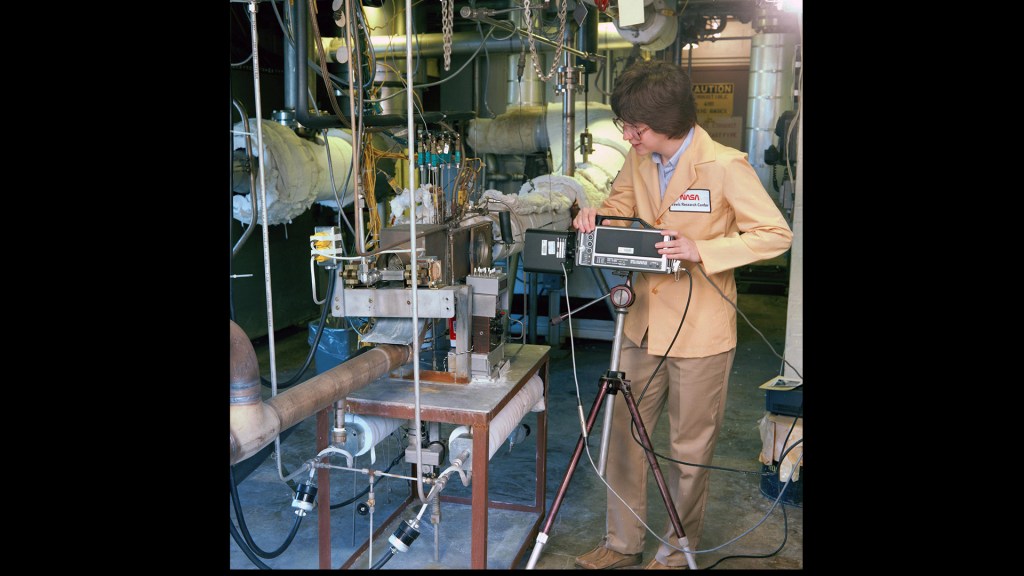 Woman working on test rig.