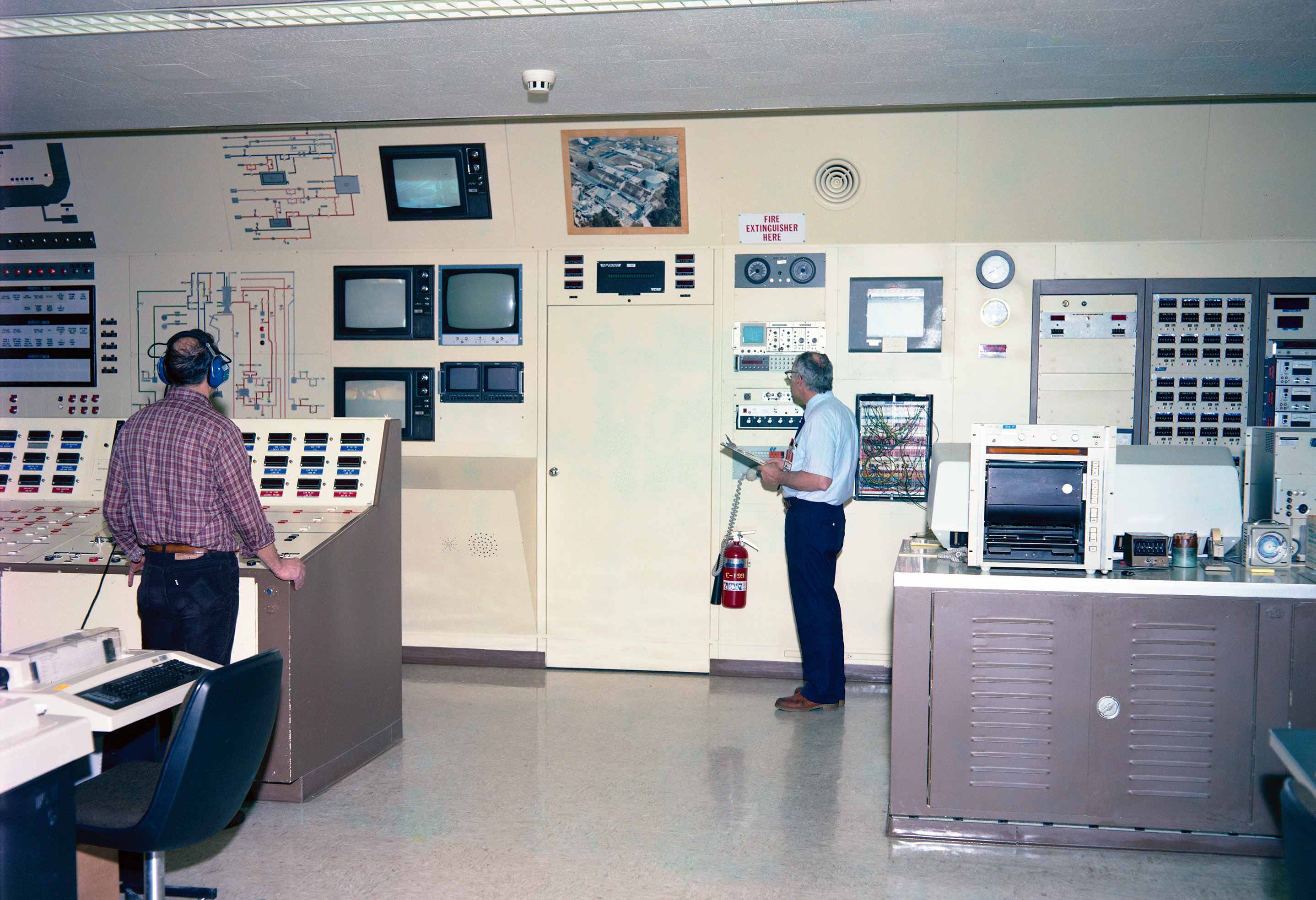 RETF control room showing system schematic, television monitors, and control panels (1987).