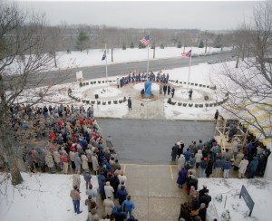 Group around flagpole in the snow.