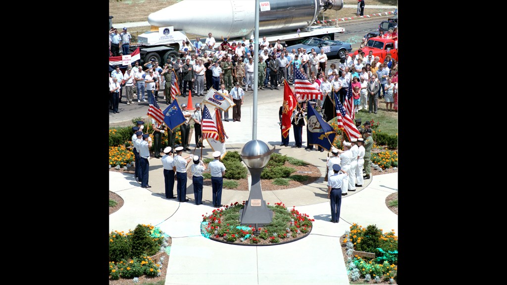 Group gathered around flagpole.